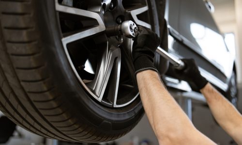 Mechanic,Performing,Tire,Maintenance,Using,Tools,In,Auto,Repair,Shop. Mechanic,Performing,Tire,Maintenance,Using,Tools,In,Auto,Repair,Shop.
